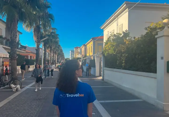 Passeggiata nel centro storico di Marina di Cecina, tra palme e case colorate.