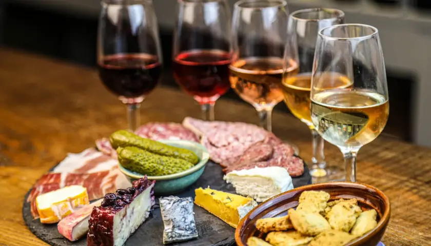 Calici di vini naturali a Firenze, accompagnati da salumi, formaggi e sottaceti. Un'esperienza gustosa.