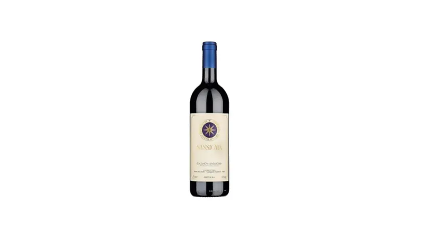 A bottle of Sassicaia wine with a blue cap and a cream-colored label featuring a compass rose.